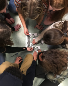 Students working on a jigsaw puzzle.